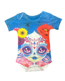 A colorful baby onesie with a Catrina design, featuring a skull with decorative patterns in black, pink, and white colors, surrounded by vibrant floral patterns.